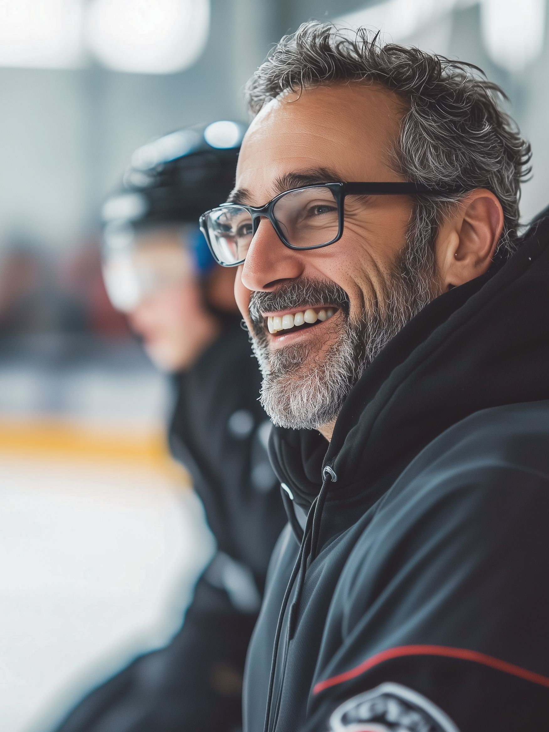 A smiling ice hockey coach.